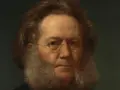 Porträtt av Henrik Ibsen med sitt karaktäristiska skägg och glasögon. Hans blick är intensiv och tankfull.