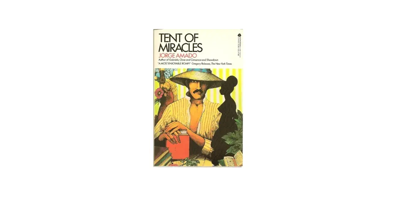 Omslag till "Tent of Miracles" av Jorge Amado. En man med hatt och mustasch sitter vid ett bord med böcker.