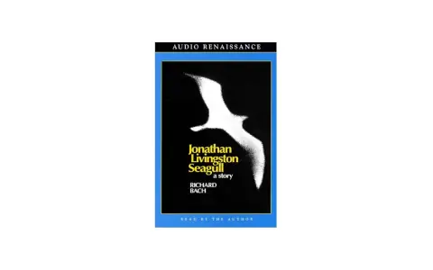 Audiobokomslag för "Jonathan Livingston Seagull" av Richard Bach, med en vit mås mot svart bakgrund.