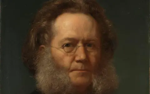 Porträtt av Henrik Ibsen med sitt karaktäristiska skägg och glasögon. Hans blick är intensiv och tankfull.