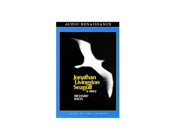 Audiobokomslag för "Jonathan Livingston Seagull" av Richard Bach, med en vit mås mot svart bakgrund.
